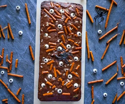 Chocolate monster eye cake studded with candy eyes and pretzel sticks (Easy Cooking with Molly)
